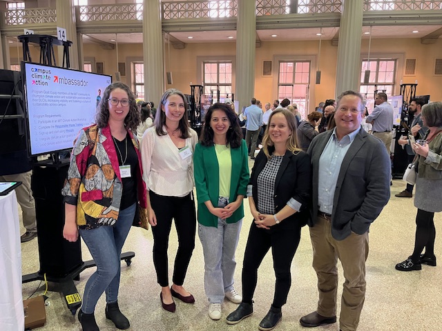 group of people stand at a poster session